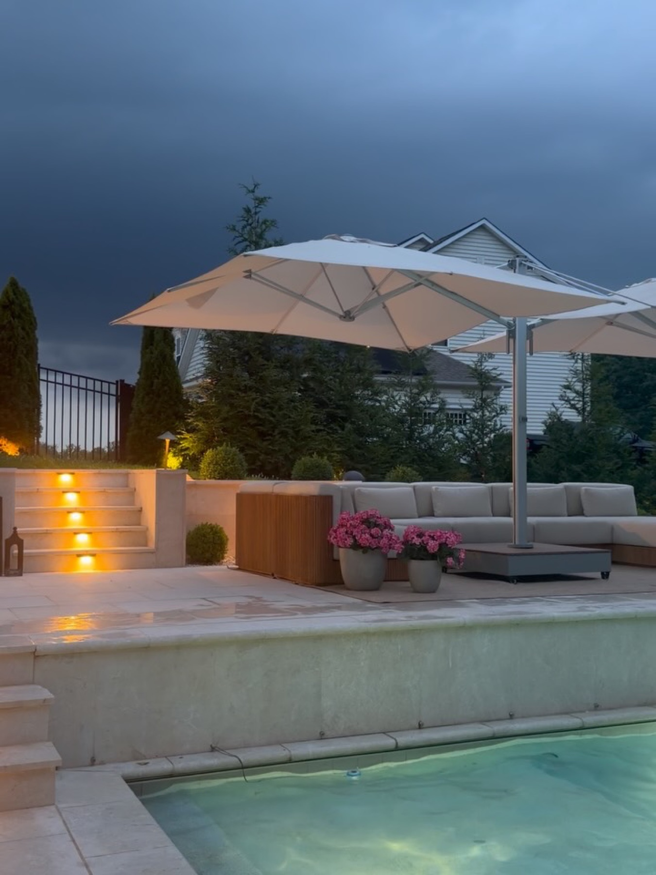 The Gulati family home and pool at dusk